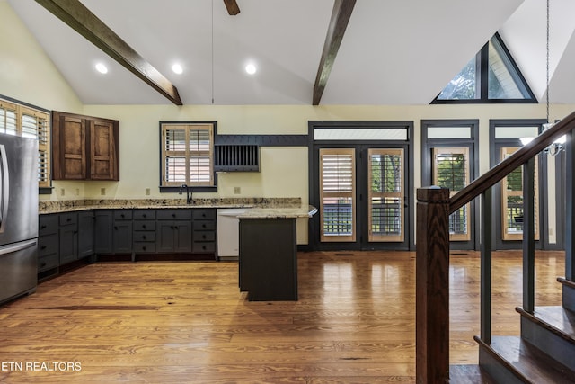 310 Savannah Shores Dr, Delano, TN 37325 - kitchen featuring appliances with stainless steel finishes, beamed ceiling, light wood-style flooring, light stone countertops, and high vaulted ceiling
