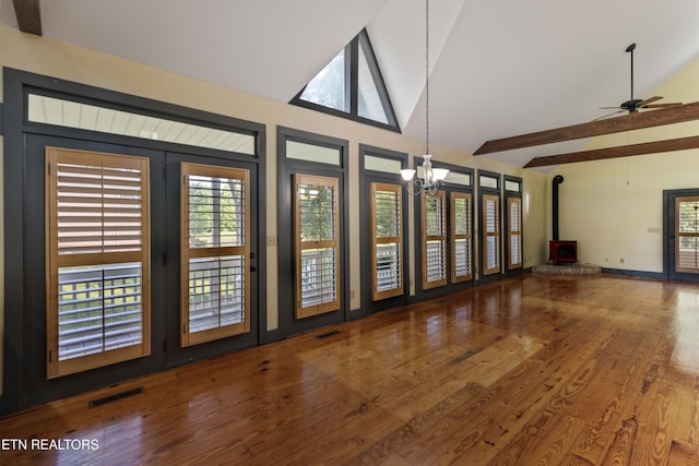 310 Savannah Shores Dr, Delano, TN 37325 - unfurnished living room with a wood stove, a chandelier, wood finished floors, a ceiling fan, and high vaulted ceiling