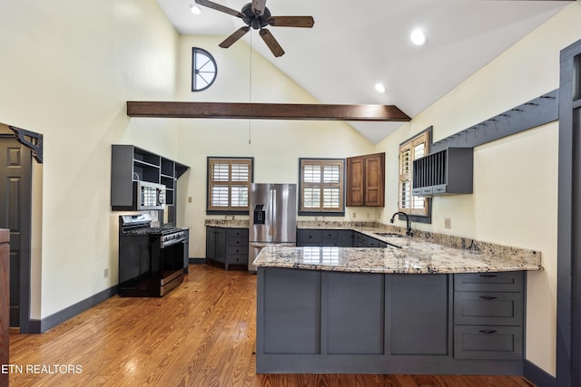 310 Savannah Shores Dr, Delano, TN 37325 - kitchen featuring stainless steel appliances, a peninsula, a ceiling fan, light stone countertops, and open shelves