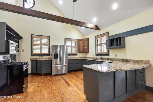 310 Savannah Shores Dr, Delano, TN 37325 - kitchen with stainless steel appliances, lofted ceiling, a peninsula, gray cabinets, and a sink