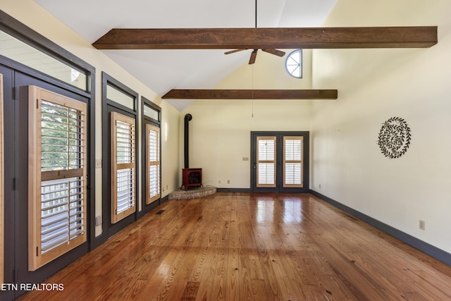 310 Savannah Shores Dr, Delano, TN 37325 - unfurnished living room with a wood stove, hardwood / wood-style flooring, ceiling fan, and baseboards