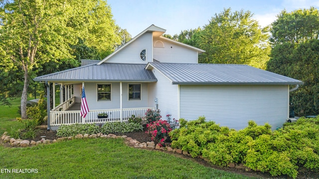 310 Savannah Shores Dr, Delano, TN 37325 - view of property exterior featuring a porch, a lawn, and metal roof