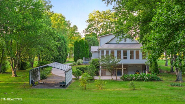 310 Savannah Shores Dr, Delano, TN 37325 - back of house featuring a yard and metal roof