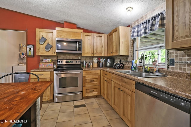 60 Greenview Ln, Crossville, TN 38571 - kitchen with appliances with stainless steel finishes, lofted ceiling, a sink, tasteful backsplash, and a textured ceiling