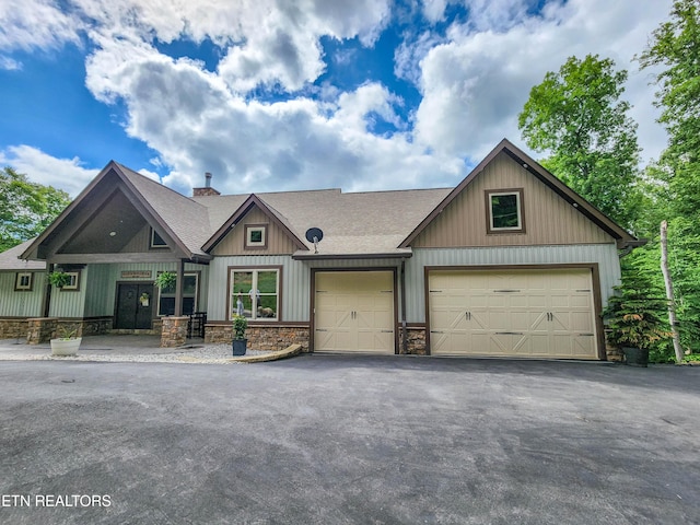 635 Norris Shores Dr, Sharps Chapel, TN 37866 - craftsman inspired home featuring an attached garage, asphalt driveway, a shingled roof, and stone siding