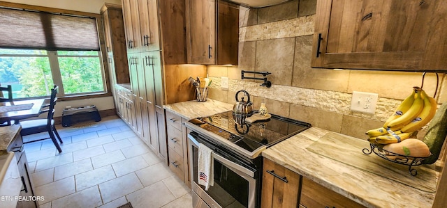 635 Norris Shores Dr, Sharps Chapel, TN 37866 - kitchen with electric stove, tasteful backsplash, brown cabinets, and light stone counters