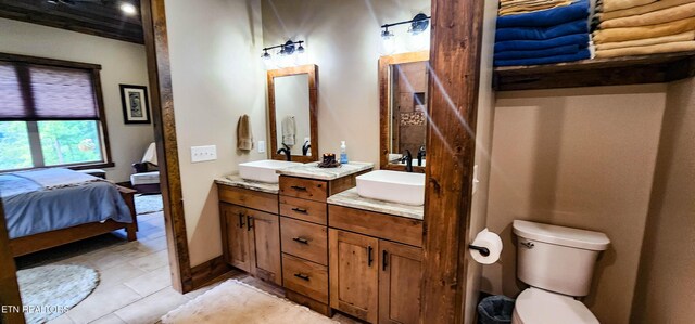 635 Norris Shores Dr, Sharps Chapel, TN 37866 - ensuite bathroom with double vanity, tile patterned floors, and toilet