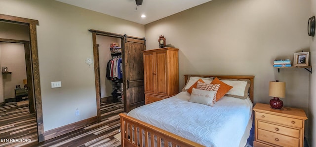 635 Norris Shores Dr, Sharps Chapel, TN 37866 - bedroom with wood finished floors, baseboards, a barn door, a closet, and recessed lighting