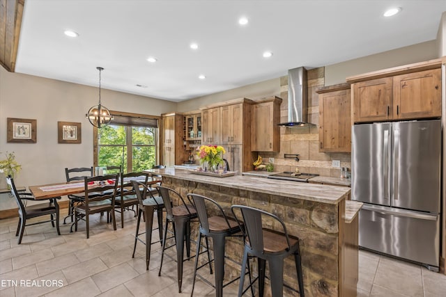 635 Norris Shores Dr, Sharps Chapel, TN 37866 - kitchen featuring freestanding refrigerator, wall chimney range hood, recessed lighting, tasteful backsplash, and light stone countertops