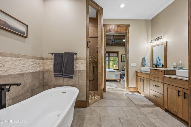 635 Norris Shores Dr, Sharps Chapel, TN 37866 - ensuite bathroom featuring tile walls, a freestanding tub, vanity, a tile shower, and tile patterned flooring