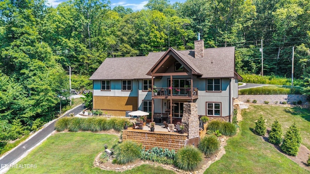 635 Norris Shores Dr, Sharps Chapel, TN 37866 - back of property with a patio area, a chimney, a lawn, stone siding, and a shingled roof
