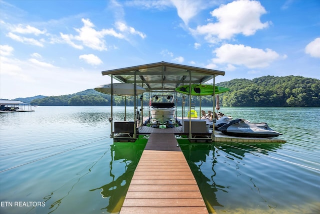 635 Norris Shores Dr, Sharps Chapel, TN 37866 - dock area with boat lift, a water view, and a wooded view