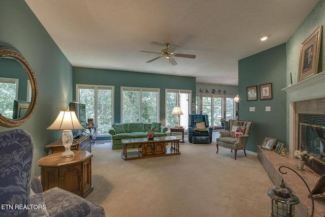 307 Okmulgee Cir, Loudon, TN 37774 - carpeted living room featuring a ceiling fan, a tiled fireplace, and a textured ceiling
