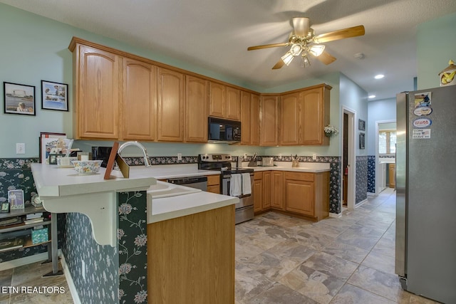 307 Okmulgee Cir, Loudon, TN 37774 - kitchen with stainless steel appliances, a peninsula, ceiling fan, and light countertops