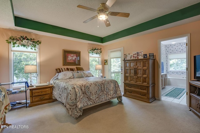 307 Okmulgee Cir, Loudon, TN 37774 - bedroom with light colored carpet, ensuite bath, ceiling fan, and a textured ceiling
