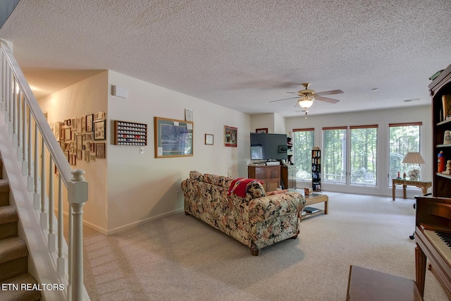 307 Okmulgee Cir, Loudon, TN 37774 - living area featuring carpet floors, a ceiling fan, stairs, a textured ceiling, and baseboards
