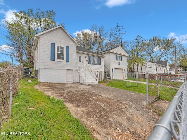 1245 Virginia Ave, Knoxville, TN 37921 - view of front facade with driveway, a garage, central air condition unit, and stairway