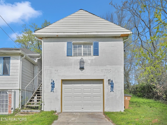 1245 Virginia Ave, Knoxville, TN 37921 - view of front of property with a garage, stairs, and concrete block siding