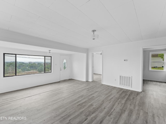 1245 Virginia Ave, Knoxville, TN 37921 - unfurnished living room with wood finished floors, healthy amount of natural light, and baseboards