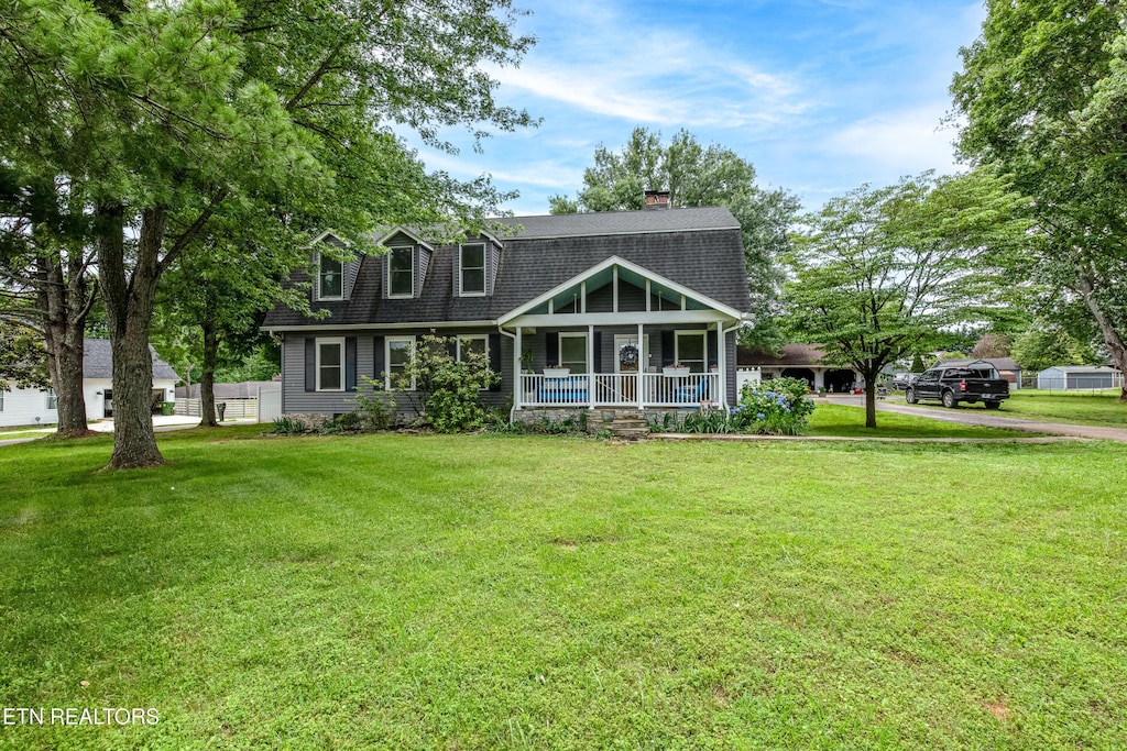 209 Montgomery Ln, Maryville, TN 37803 - view of front facade with a porch, a front yard, a chimney, and roof with shingles