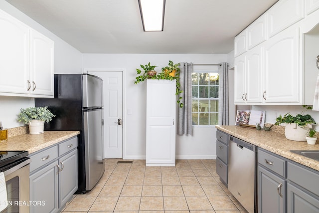 409 Melrose St, Maryville, TN 37803 - kitchen featuring appliances with stainless steel finishes, gray cabinets, white cabinetry, and light countertops