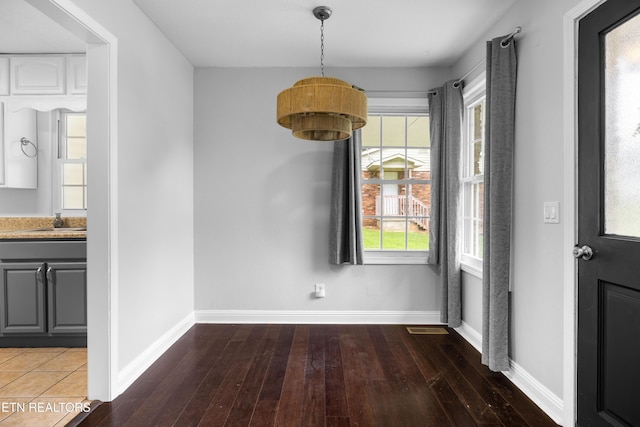 409 Melrose St, Maryville, TN 37803 - unfurnished dining area featuring hardwood / wood-style floors and baseboards