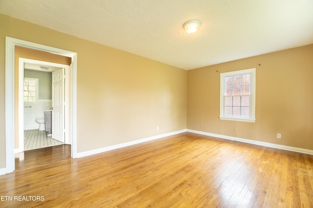 714 E Emerald Ave, Knoxville, TN 37917 - spare room featuring light wood-type flooring, plenty of natural light, and baseboards