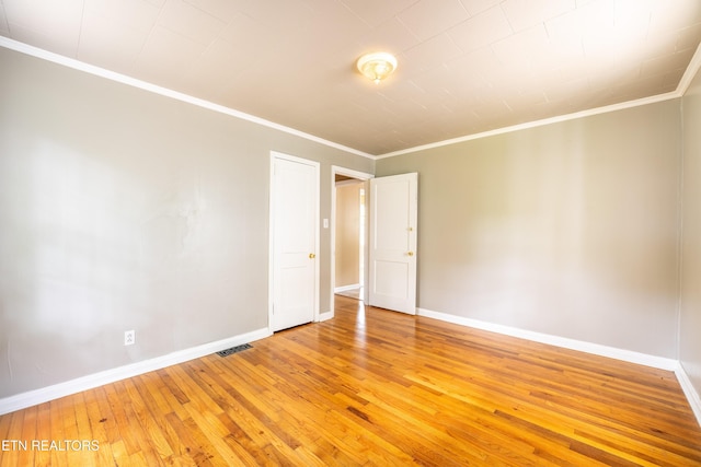 714 E Emerald Ave, Knoxville, TN 37917 - empty room featuring light wood finished floors, baseboards, and crown molding