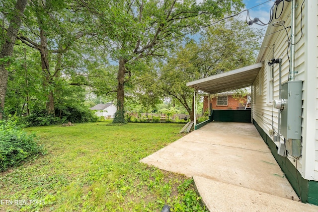 714 E Emerald Ave, Knoxville, TN 37917 - view of green lawn featuring an attached carport and a patio