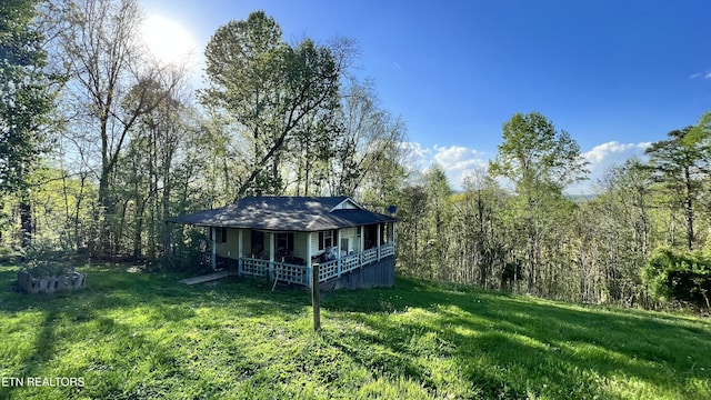 647 S Sudenny Ln, Lafollette, TN 37766 - back of property featuring a lawn, covered porch, and a wooded view