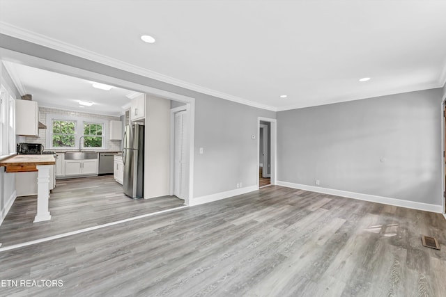 722 Southern Pkwy, Athens, TN 37303 - unfurnished living room with light wood-type flooring, a sink, baseboards, ornamental molding, and recessed lighting