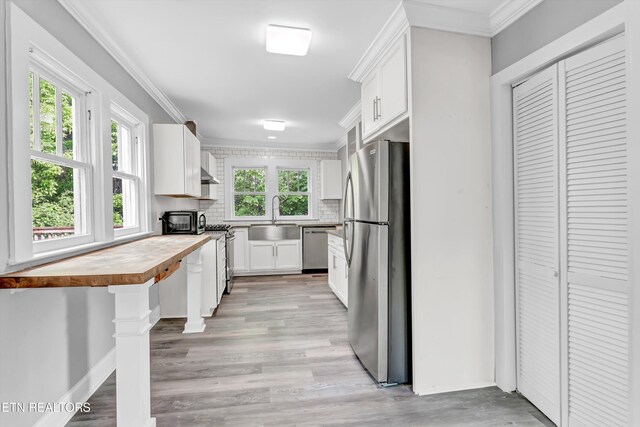 722 Southern Pkwy, Athens, TN 37303 - kitchen featuring appliances with stainless steel finishes, a sink, backsplash, butcher block countertops, and white cabinets