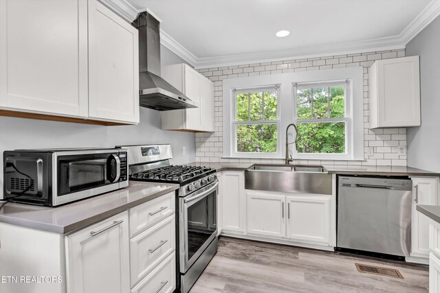 722 Southern Pkwy, Athens, TN 37303 - kitchen featuring appliances with stainless steel finishes, wall chimney exhaust hood, crown molding, a sink, and backsplash