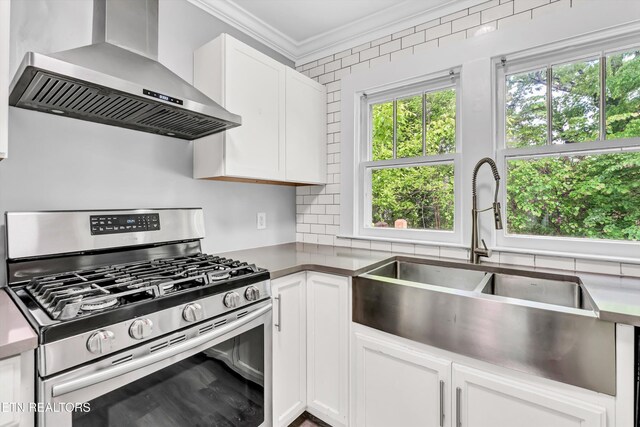 722 Southern Pkwy, Athens, TN 37303 - kitchen with gas range, wall chimney exhaust hood, a sink, ornamental molding, and white cabinetry