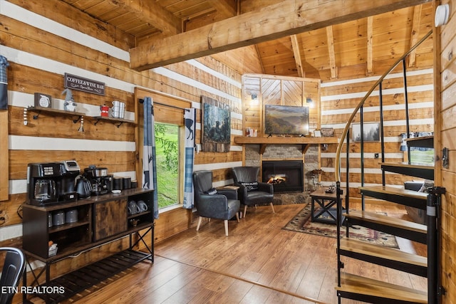 living room with wood ceiling, wood walls, hardwood / wood-style floors, and a fireplace