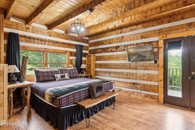 bedroom featuring wood ceiling, wood walls, wood-type flooring, beam ceiling, and access to exterior