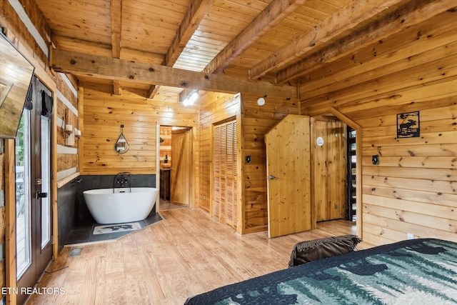 unfurnished bedroom with wooden walls, wood finished floors, beam ceiling, and wood ceiling