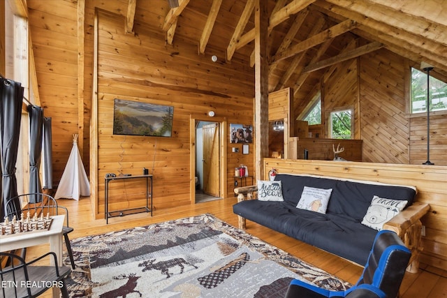 living room featuring wooden walls, hardwood / wood-style floors, and wood ceiling