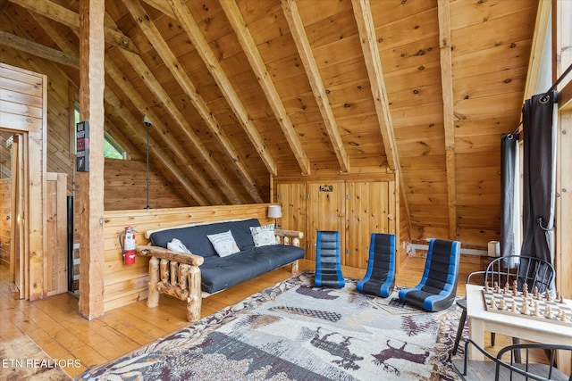 living area featuring wooden walls, wood-type flooring, and wooden ceiling