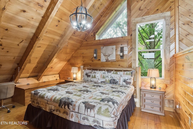 bedroom with wooden walls, wooden ceiling, and light wood finished floors