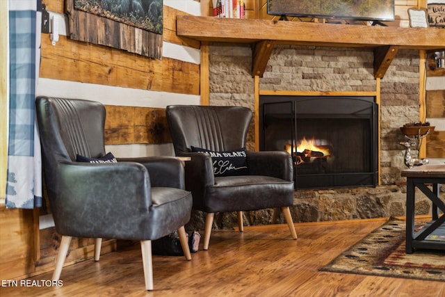 sitting room with wood finished floors and a fireplace