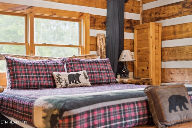 bedroom with wood walls