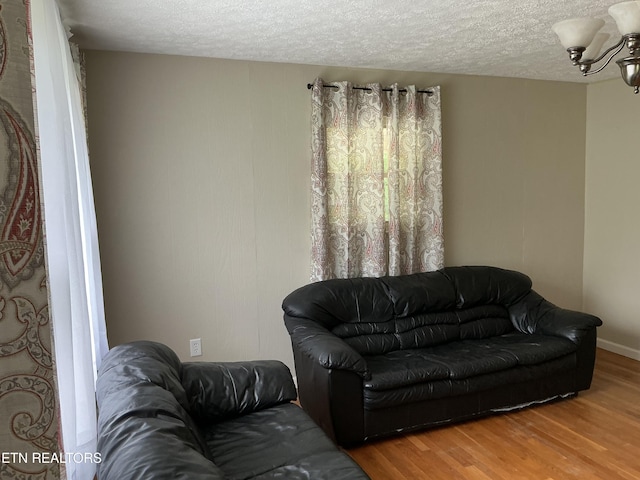 166 Stratford Rd, Harrogate, TN 37752 - living area featuring wood finished floors, a chandelier, and a textured ceiling