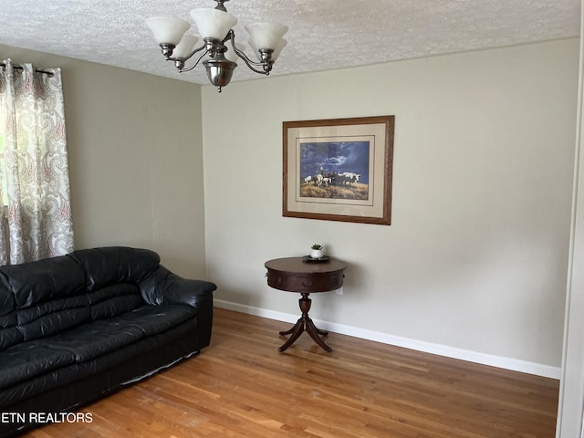 166 Stratford Rd, Harrogate, TN 37752 - living area with a chandelier, a textured ceiling, baseboards, and wood finished floors