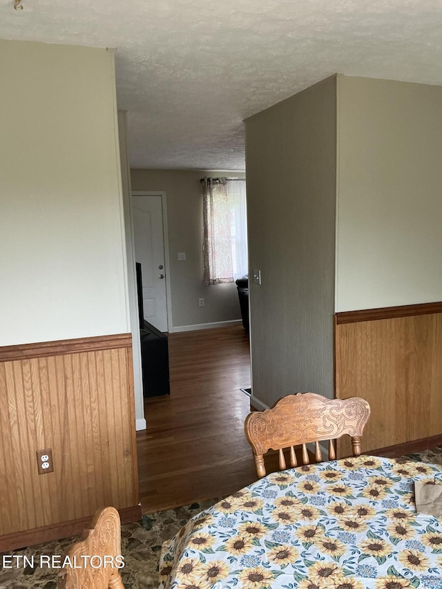166 Stratford Rd, Harrogate, TN 37752 - bedroom with wood finished floors, a wainscoted wall, a textured ceiling, and wood walls