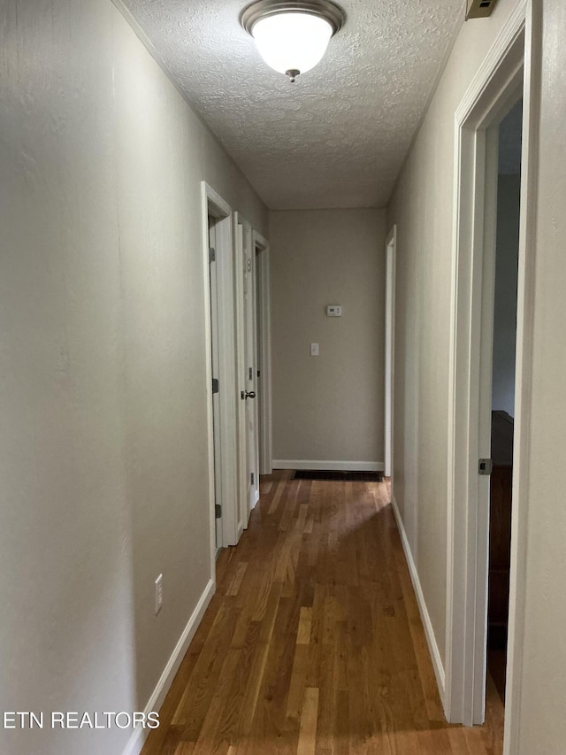 166 Stratford Rd, Harrogate, TN 37752 - hallway with a textured ceiling, wood finished floors, and baseboards