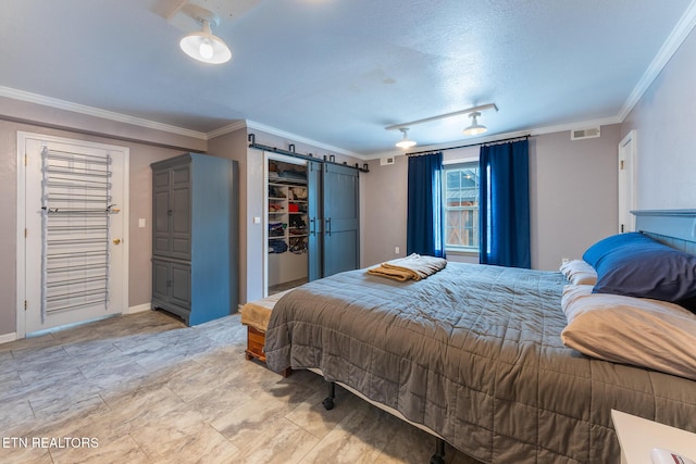 409 Turner Rd, Crossville, TN 38555 - bedroom featuring ornamental molding, a barn door, baseboards, a closet, and a spacious closet