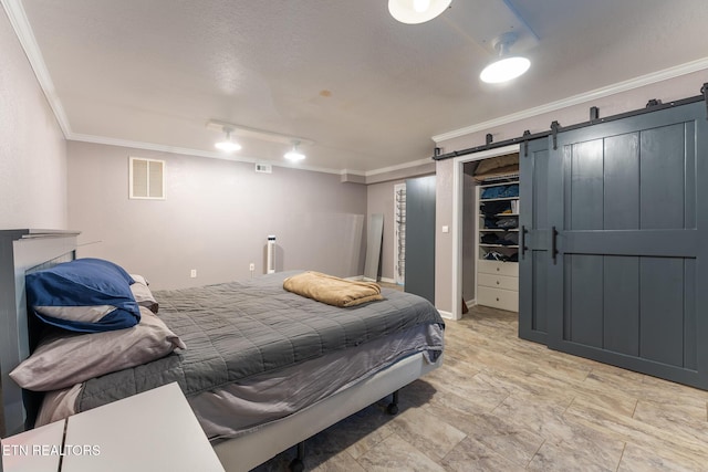 409 Turner Rd, Crossville, TN 38555 - bedroom with crown molding, a spacious closet, a barn door, and a closet