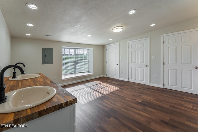 409 Turner Rd, Crossville, TN 38555 - bathroom featuring electric panel, recessed lighting, wood finished floors, a textured ceiling, and baseboards