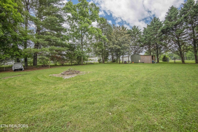 view of grassy yard with an outdoor structure